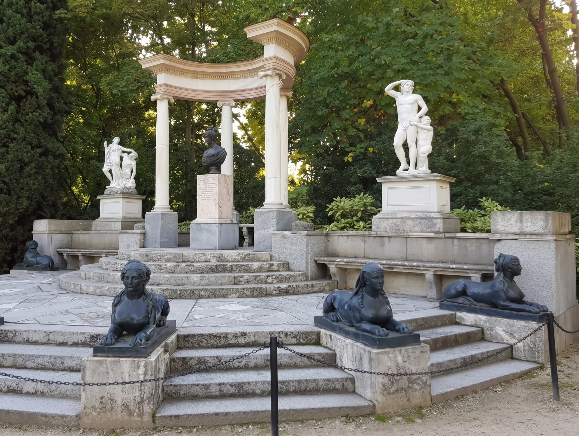 La Exedra in El Capricho, with its curved colonnade, sculptures and sphinxes among the trees